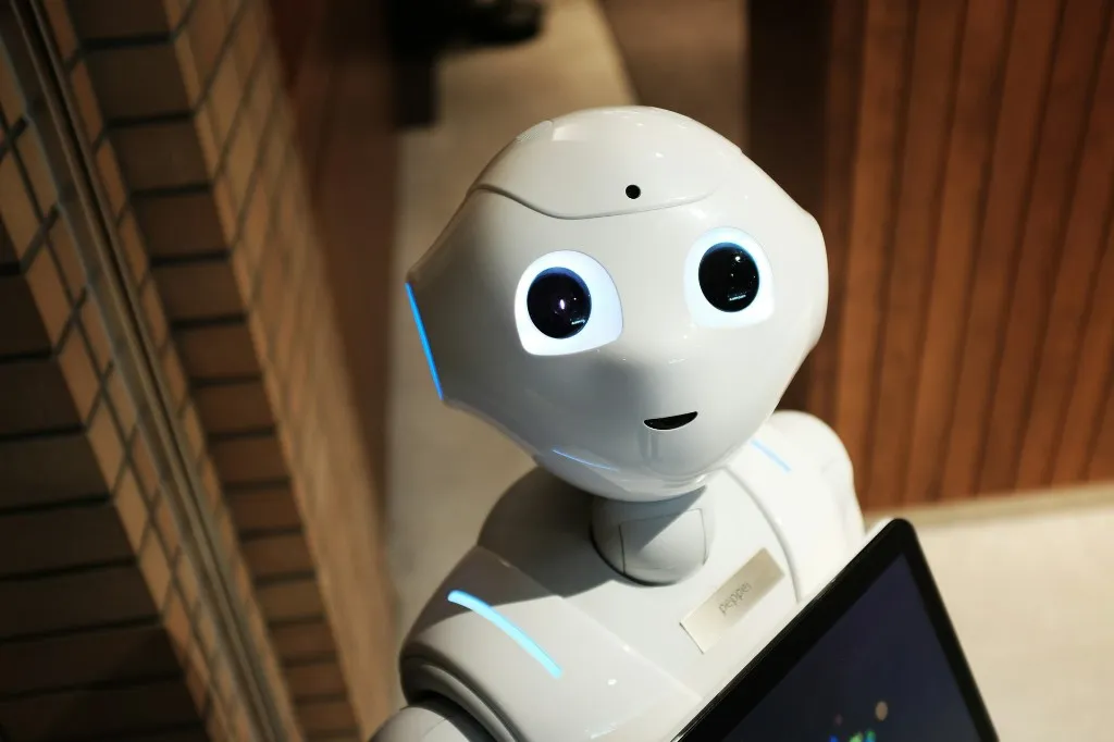 Pepper humanoid robot with glowing eyes in a modern indoor setting